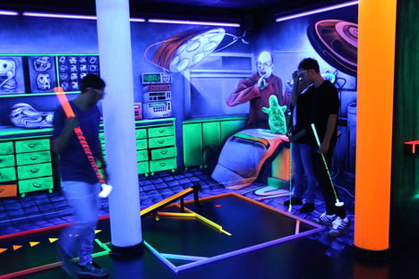 Group of visitors at an indoor minigolg session