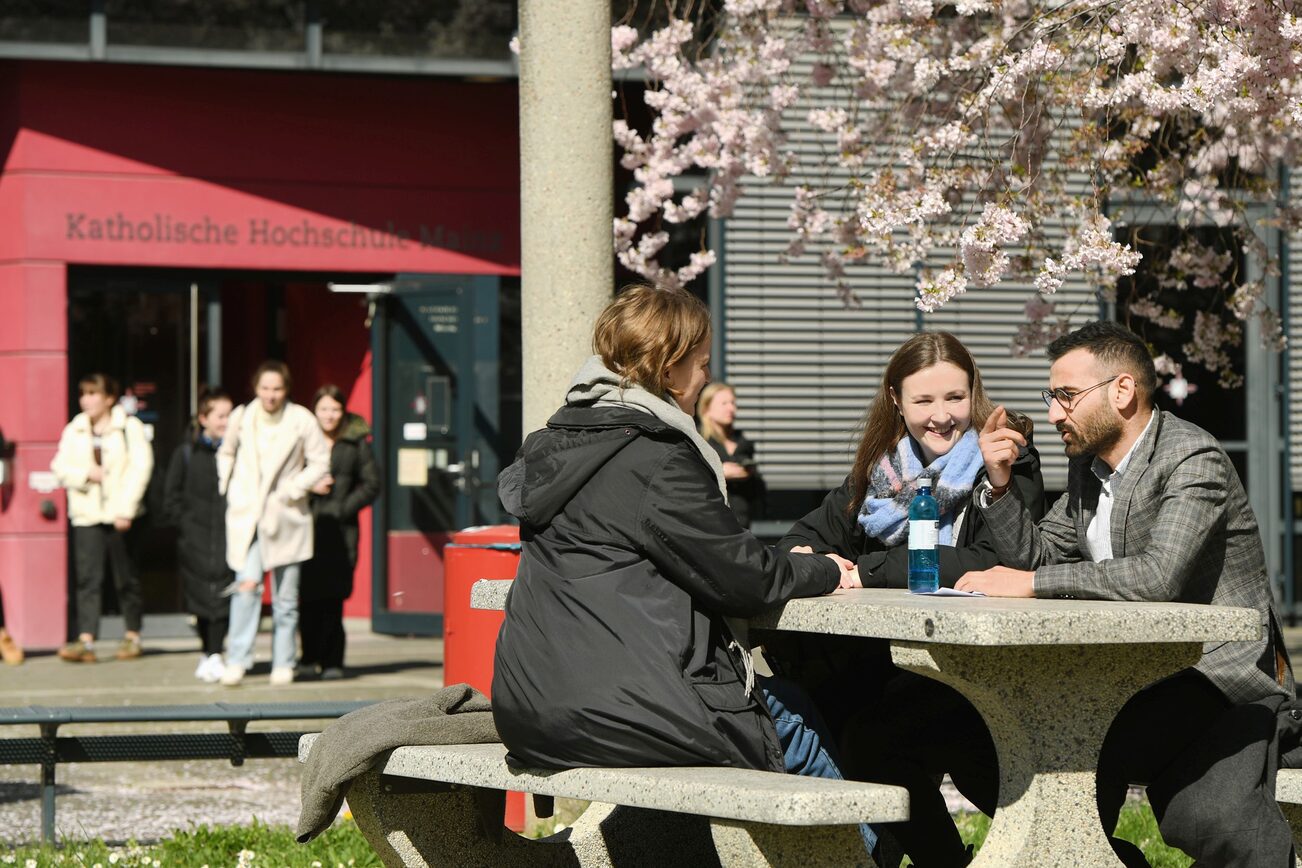 Junge Frauen sitzen auf einer Wiese