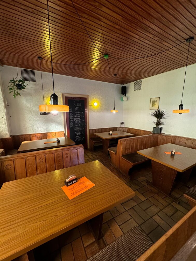The inside of the Bierstübchen with rustic tables and benches.