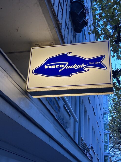 Exterior sign with fish graphic of the fish store "Fisch Jackob"