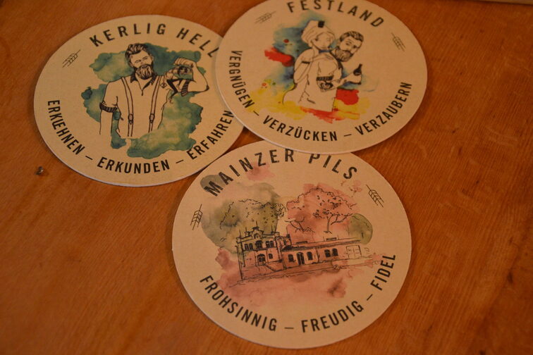Three colorful beer mats from the brewery