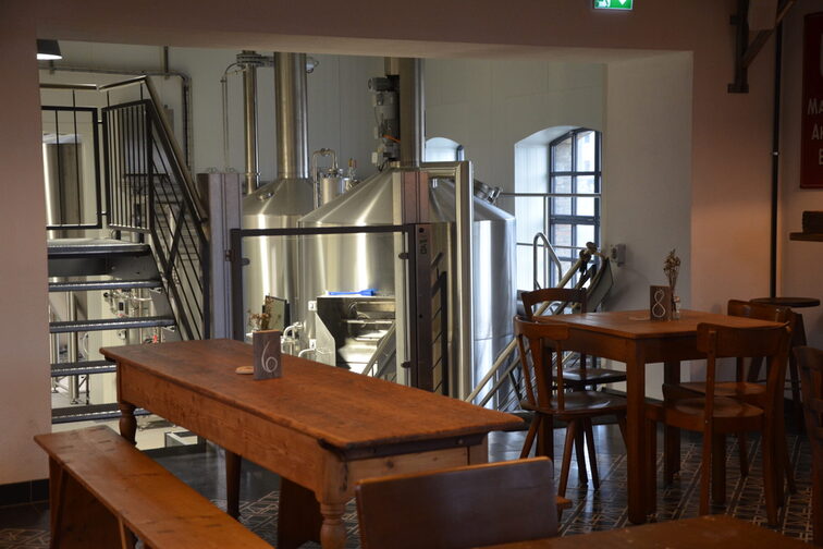 Taproom with a view of the brewery