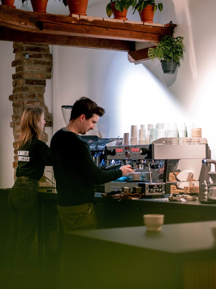 Employees making coffee.