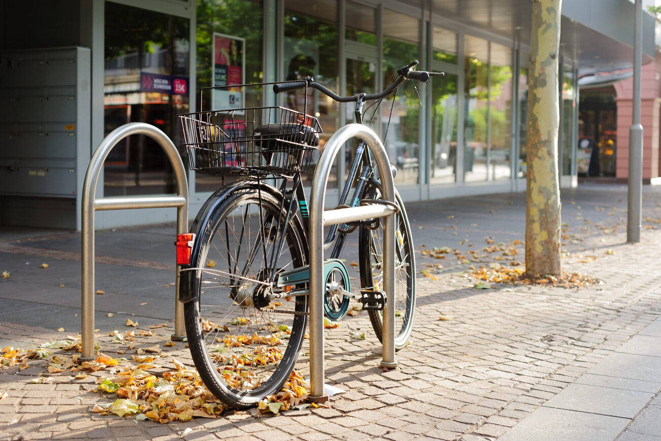 Zwei Fahrradbügel mit einem abgestellten Fahrrad in der Ludwigstraße vorm DM.