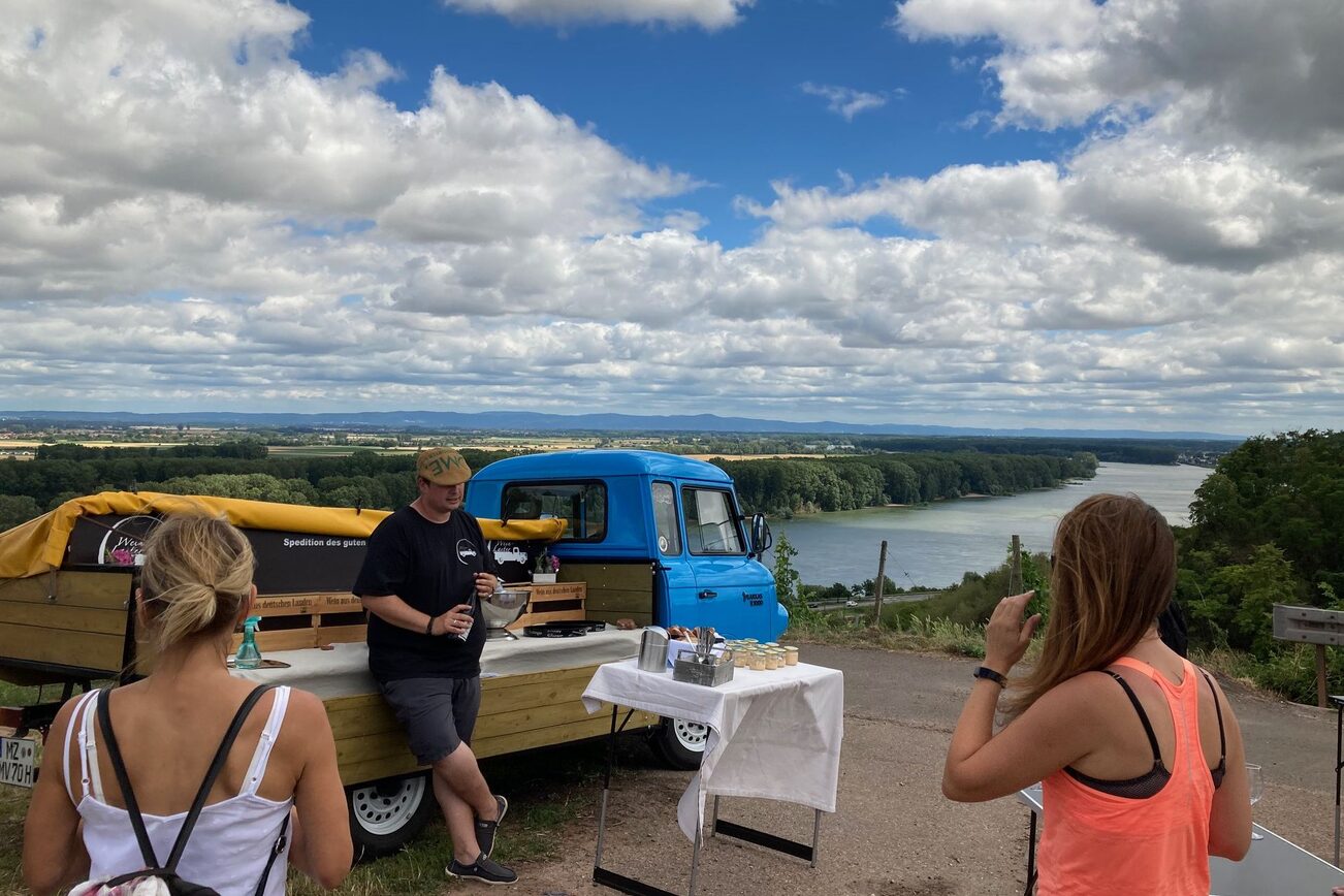 Guests enjoy wine from the wine truck with a view of the Rhine