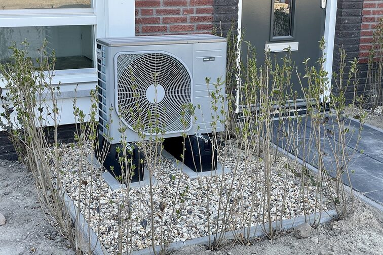 Heat pump split unit in a front garden