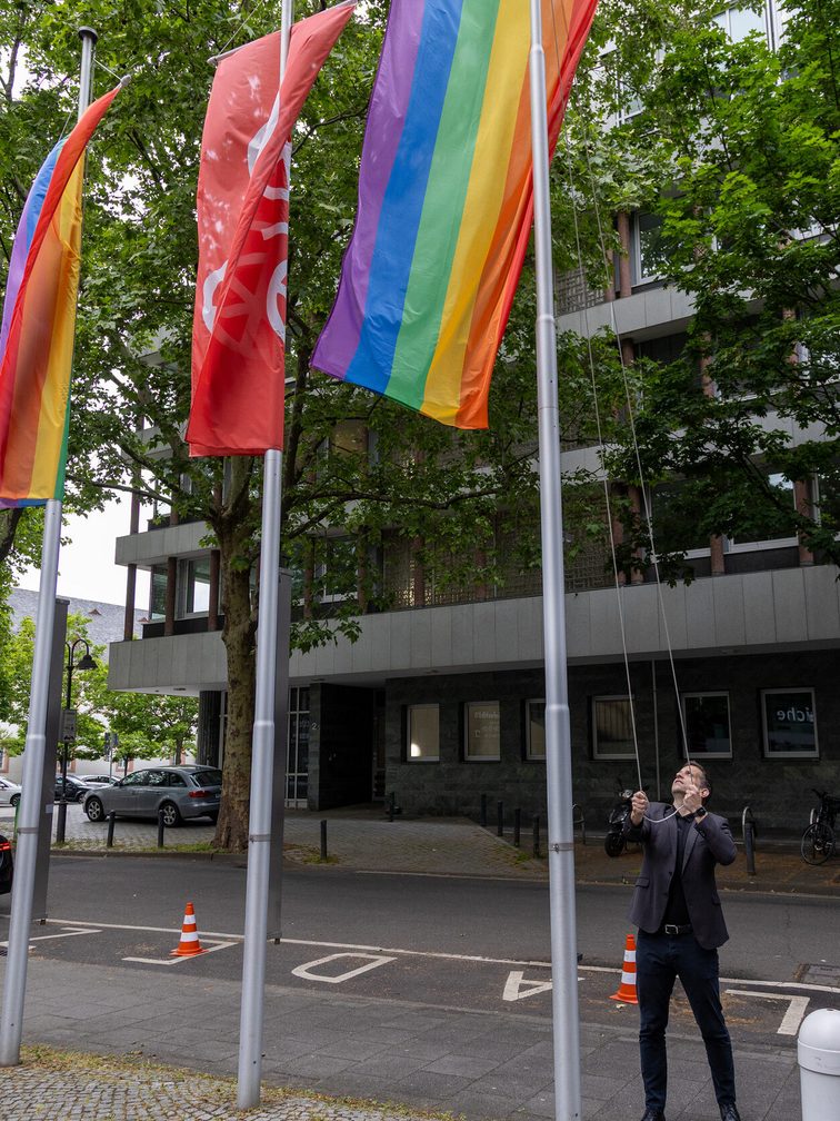 Lord Mayor Nino Haase hoists a rainbow flag