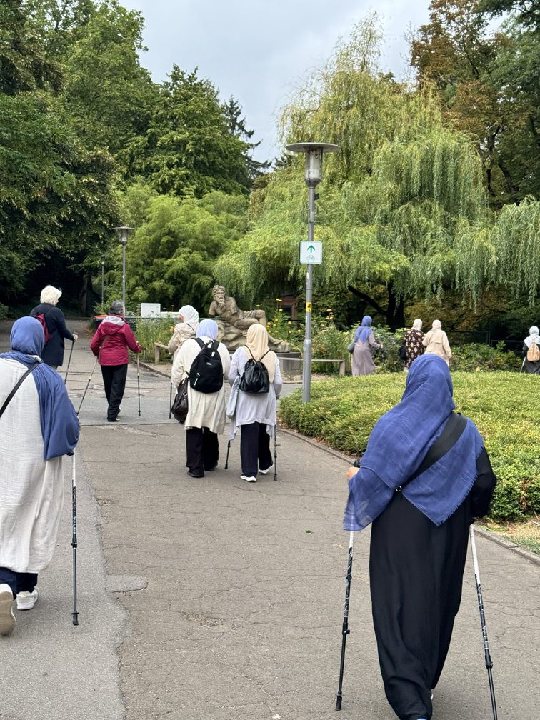 Intercultural running group for senior women runs through the city park in Mainz