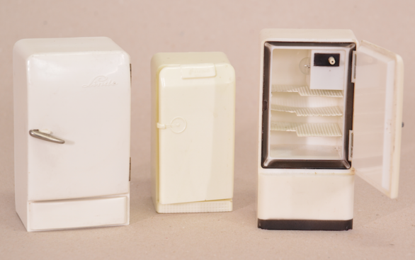 Die drei Miniaturkühlschränke aus Kunststoff – Linde (11,5 cm), Frigidaire (10 cm), Bosch, geöffnet (12 cm) – sind in ihrer Form typisch für die fünfziger Jahre.