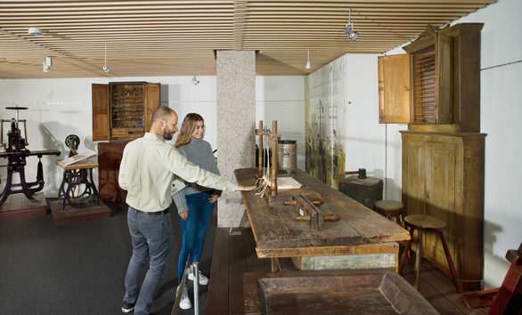 Visitors in the permanent exhibition, bookbinding section.