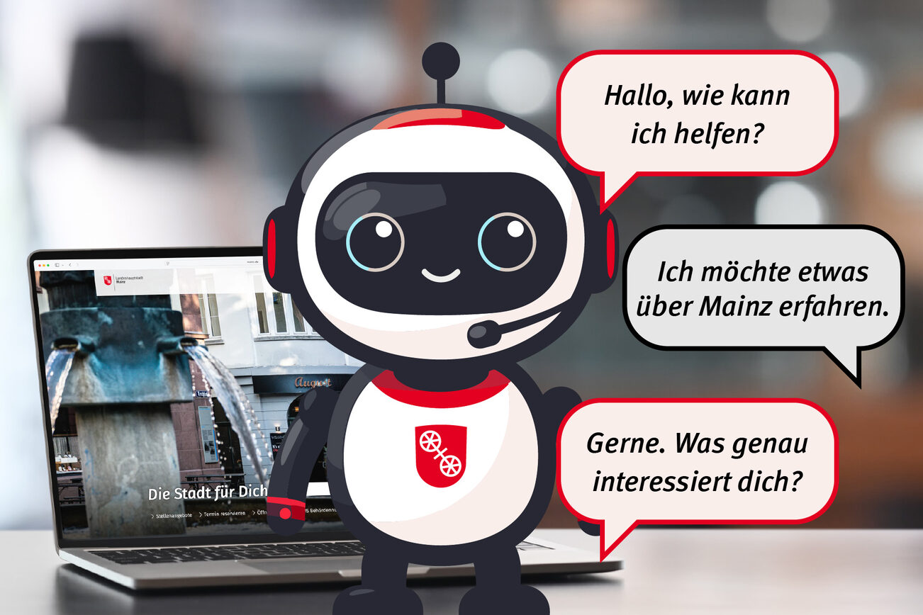 A robot figure stands in the foreground with speech bubbles, behind it is a laptop showing the home page of mainz.de