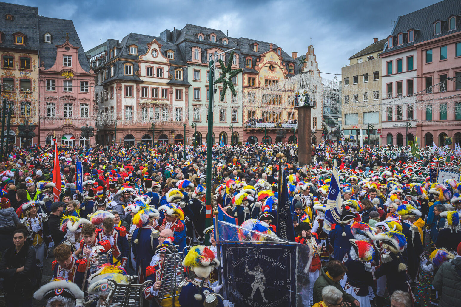 The market around the haystack is filled with people dressed up.