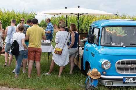 Gäste stehen am Wein-Laster Nierstein